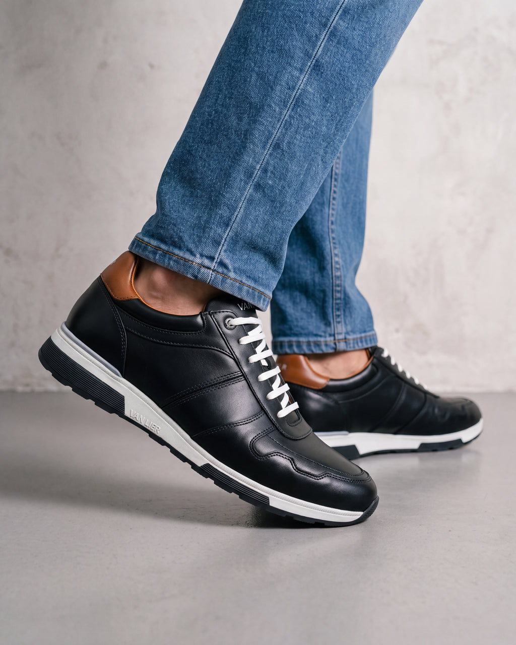 Donker Blauw gladleren Positano sneaker – close-up van het paar op beton in een atelier
