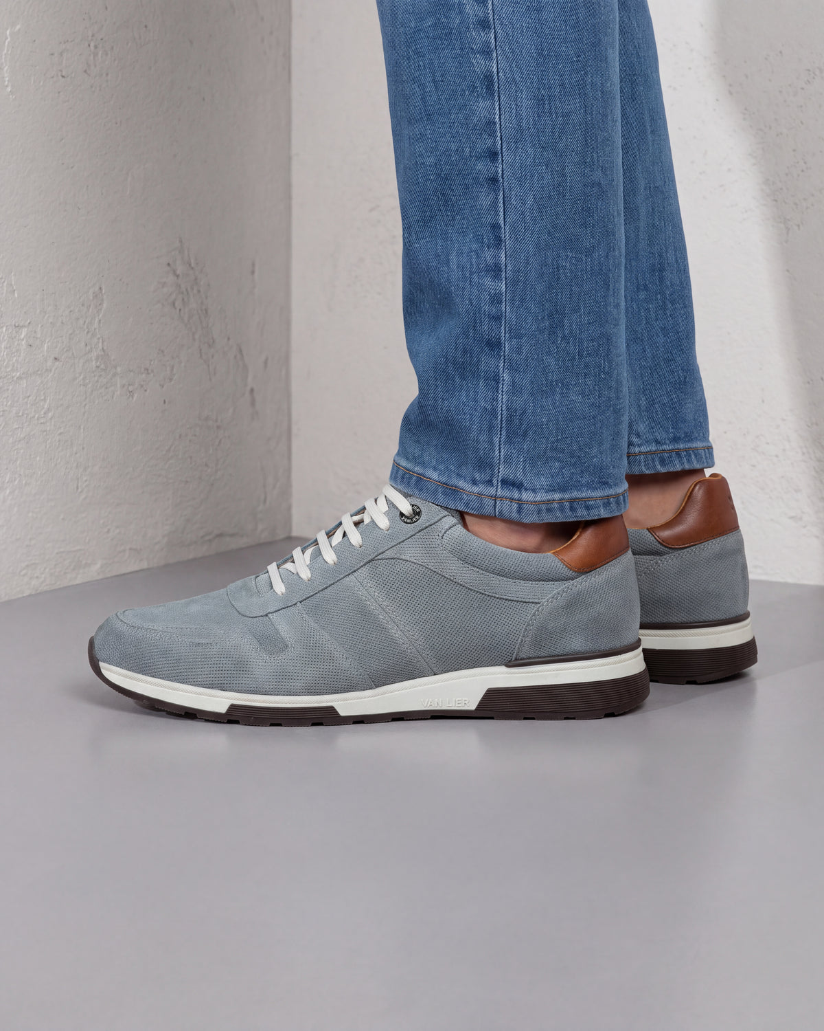 Grijs blauw suède Positano sneaker – close-up van het paar op beton in een atelier