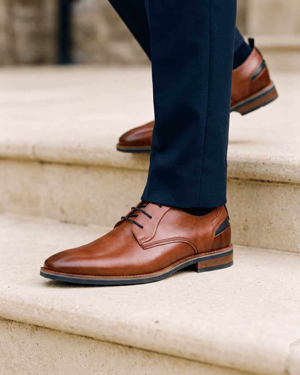 Cognac gladleren Amalfi veterschoen – close-up van het paar op kalksteen