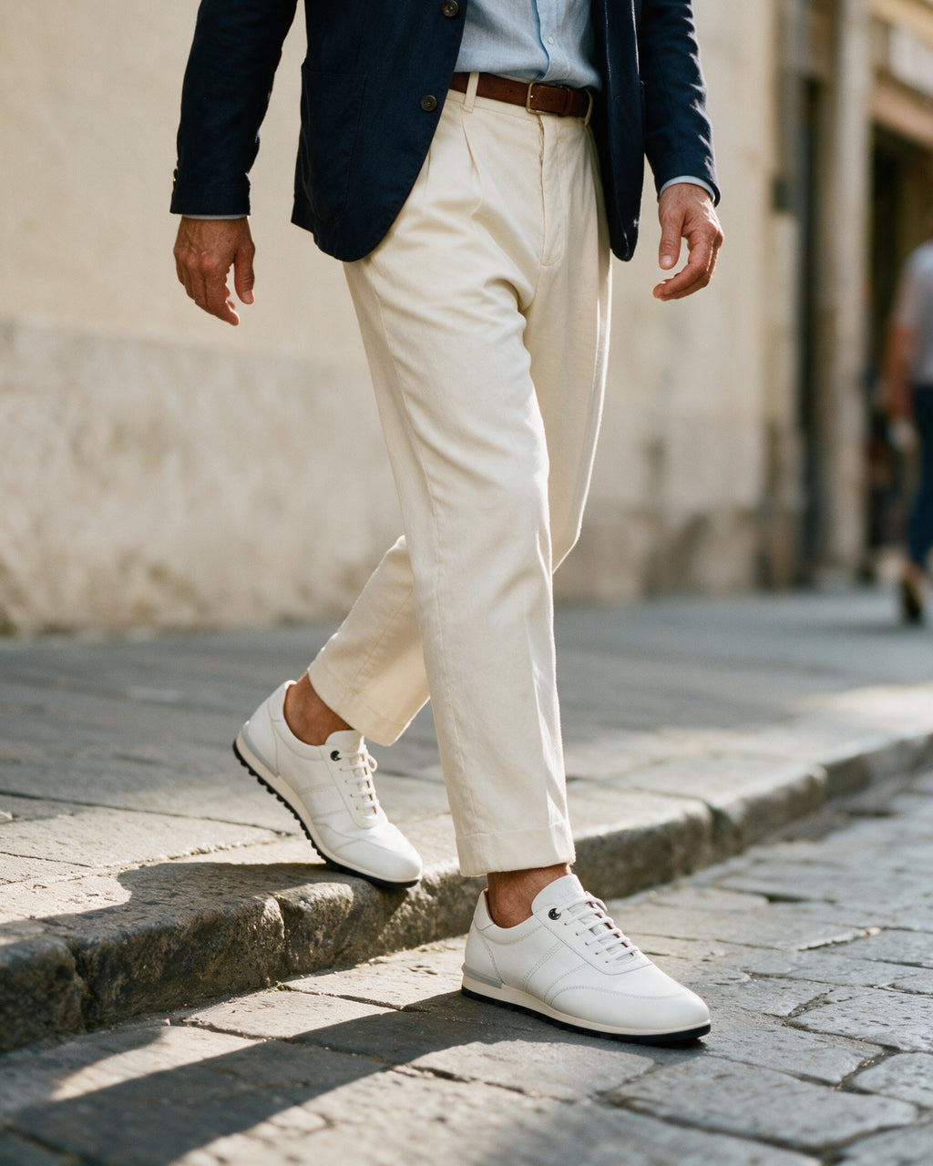 Wit gladleren Anzano sneaker – gedragen bij het afstappen van het verhoogde trottoir