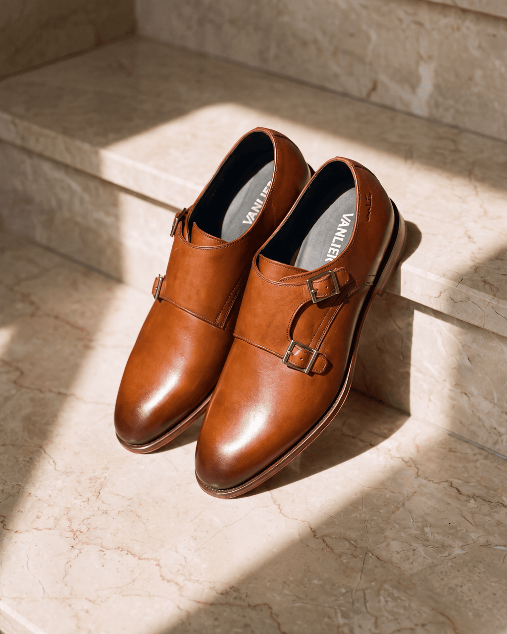 Cognac gladleren Madison gespschoen – close-up op warm marmer